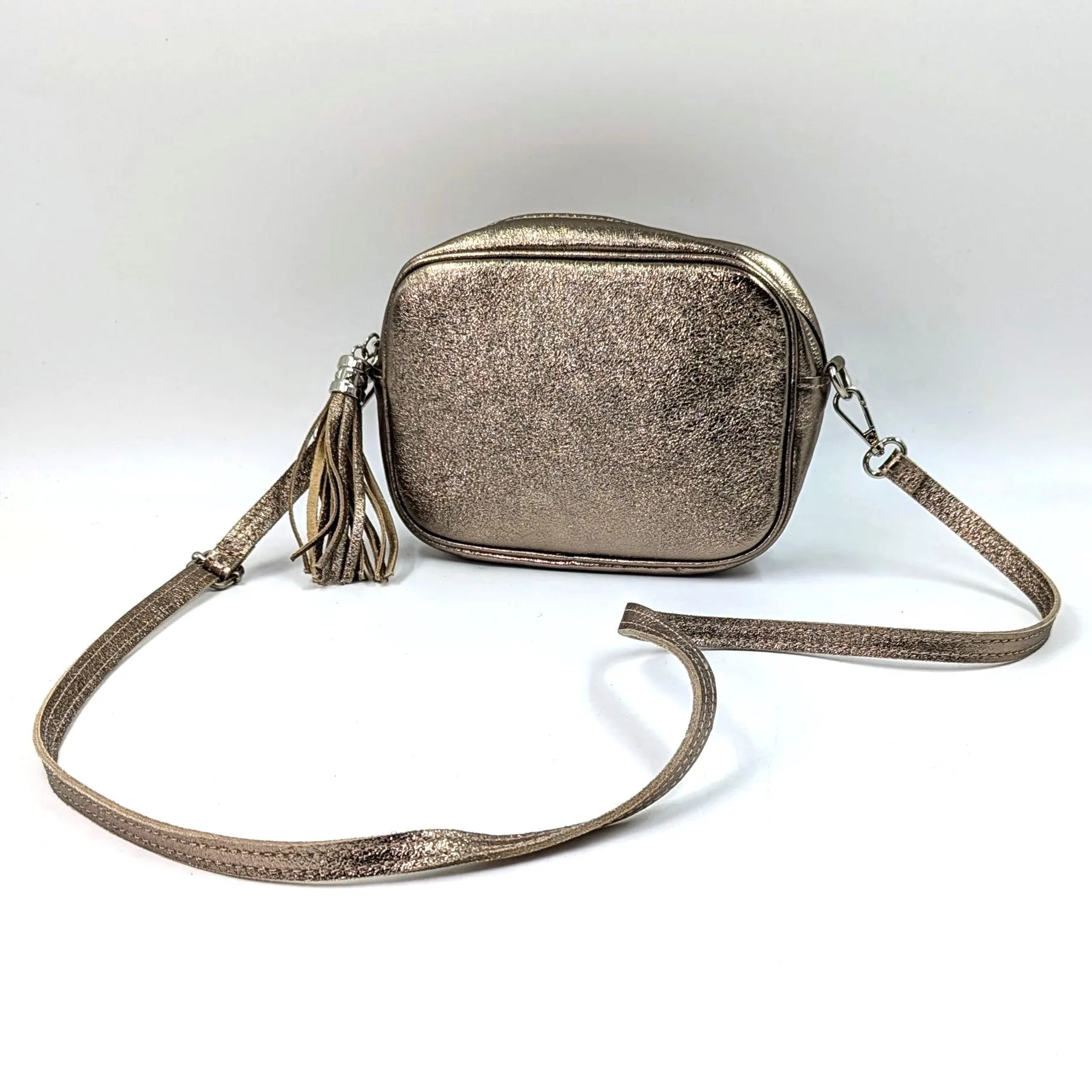 Boxy leather bag with tassel and crossbody strap